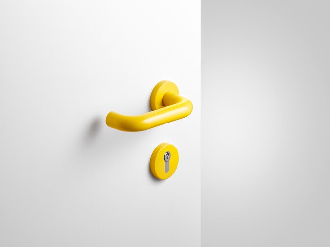 Lever handle with key rosette in the colour mustard yellow made of polyamide