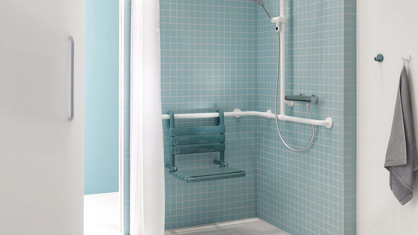 Patient bathroom with HEWI Series 477 Shower area of a patient bathroom in blue and white with a view through a sliding door