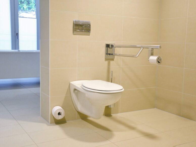 Toilet uitgerust met inklapbare steungreep, reservepapierhouder en toiletborstelset